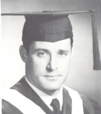 Portrait of Phil Steiner in graduation attire with cap and gown.