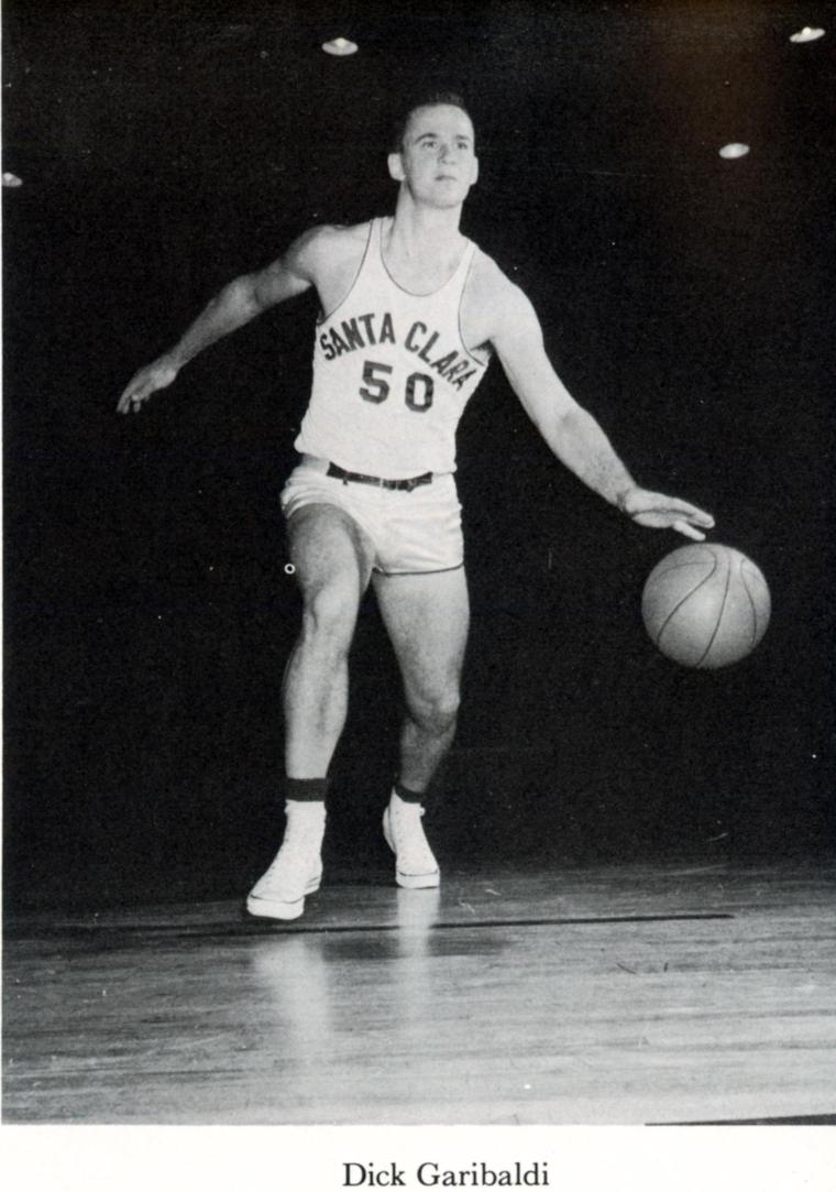 A basketball player dribbling the ball on a court.