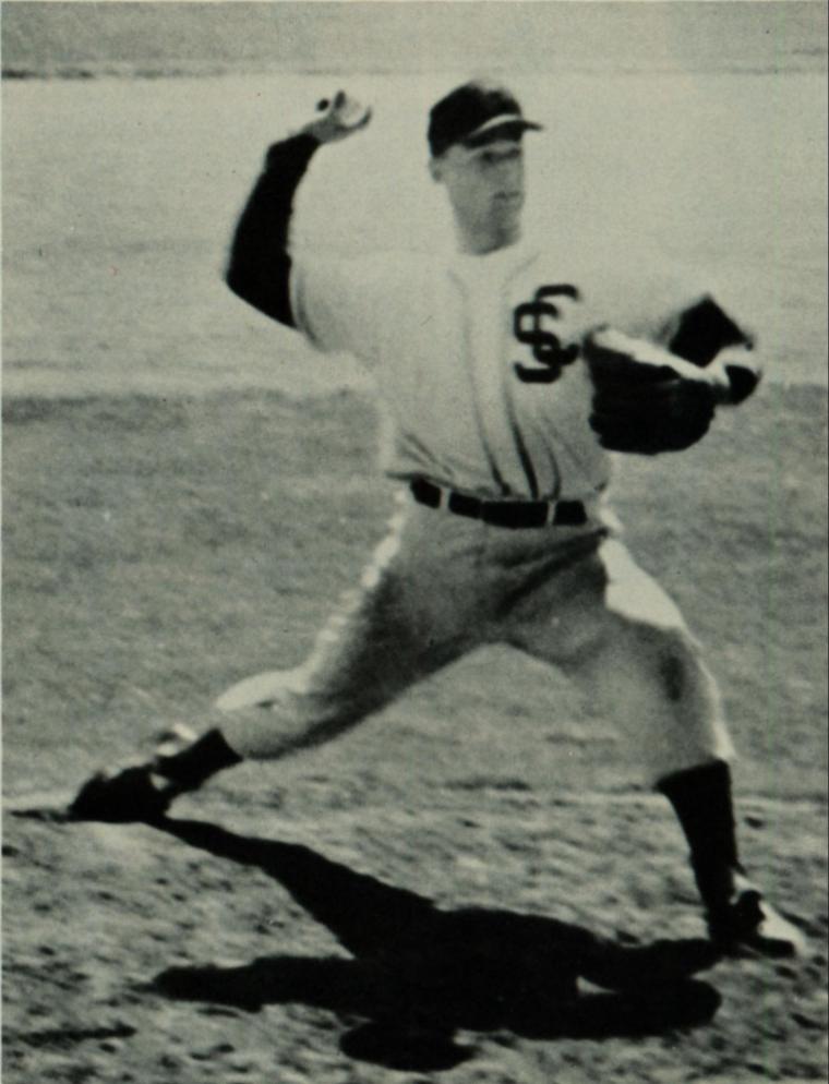 A baseball pitcher in mid-throw stance on the field, 1964.
