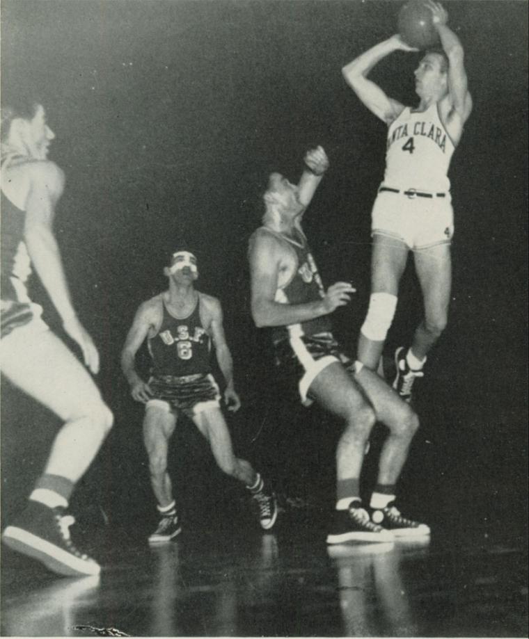 Black and white photo of basketball players in action.