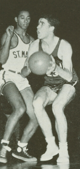 Black and white photo of two basketball players in action.