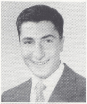 Black-and-white portrait of Ronald Modeste in a suit and tie.