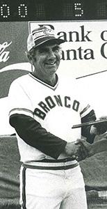 A person in a baseball uniform holding a bat.