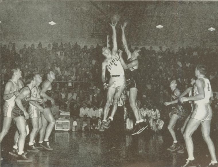 Black and white photo of a basketball game tip-off.
