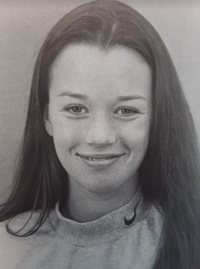 Black-and-white portrait of a person smiling.
