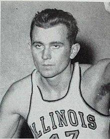 Black-and-white photo of a basketball player in an Illinois jersey.