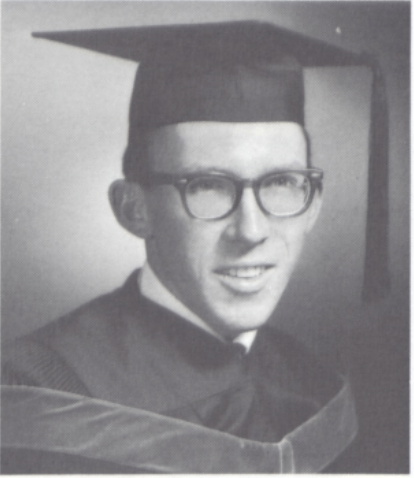 A person wearing graduation attire and glasses.