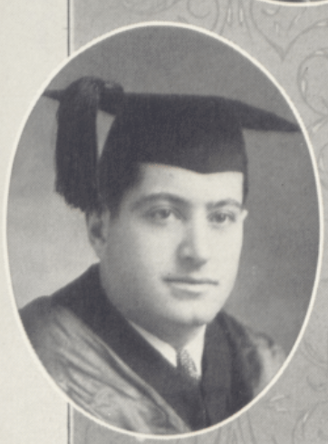 Black and white photo of a man in graduation attire.