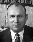 Black and white portrait of a man in a suit.