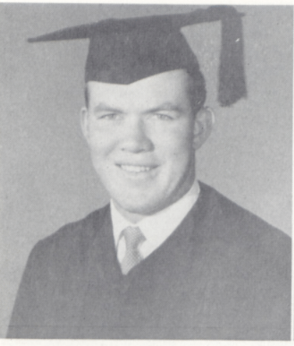 A person wearing a graduation cap and gown.