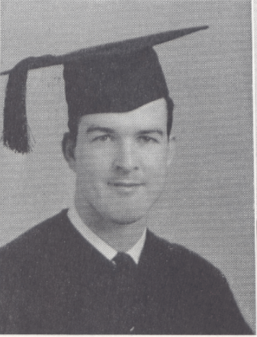 Black and white photo of a graduate in a cap and gown.