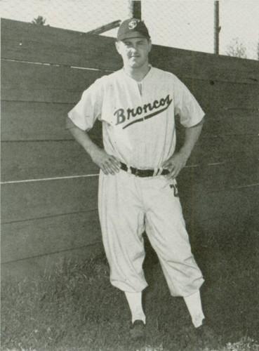 Black and white photo of a baseball player in uniform.