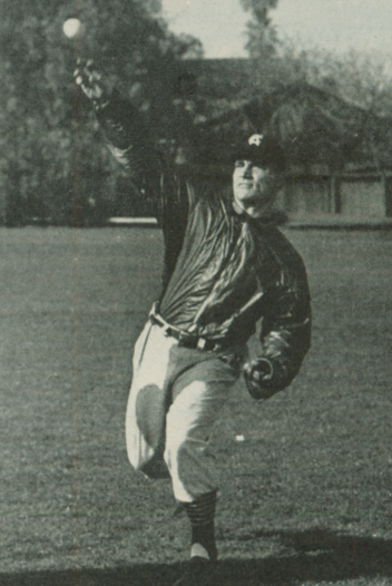 A baseball player in uniform making a throw on the field.