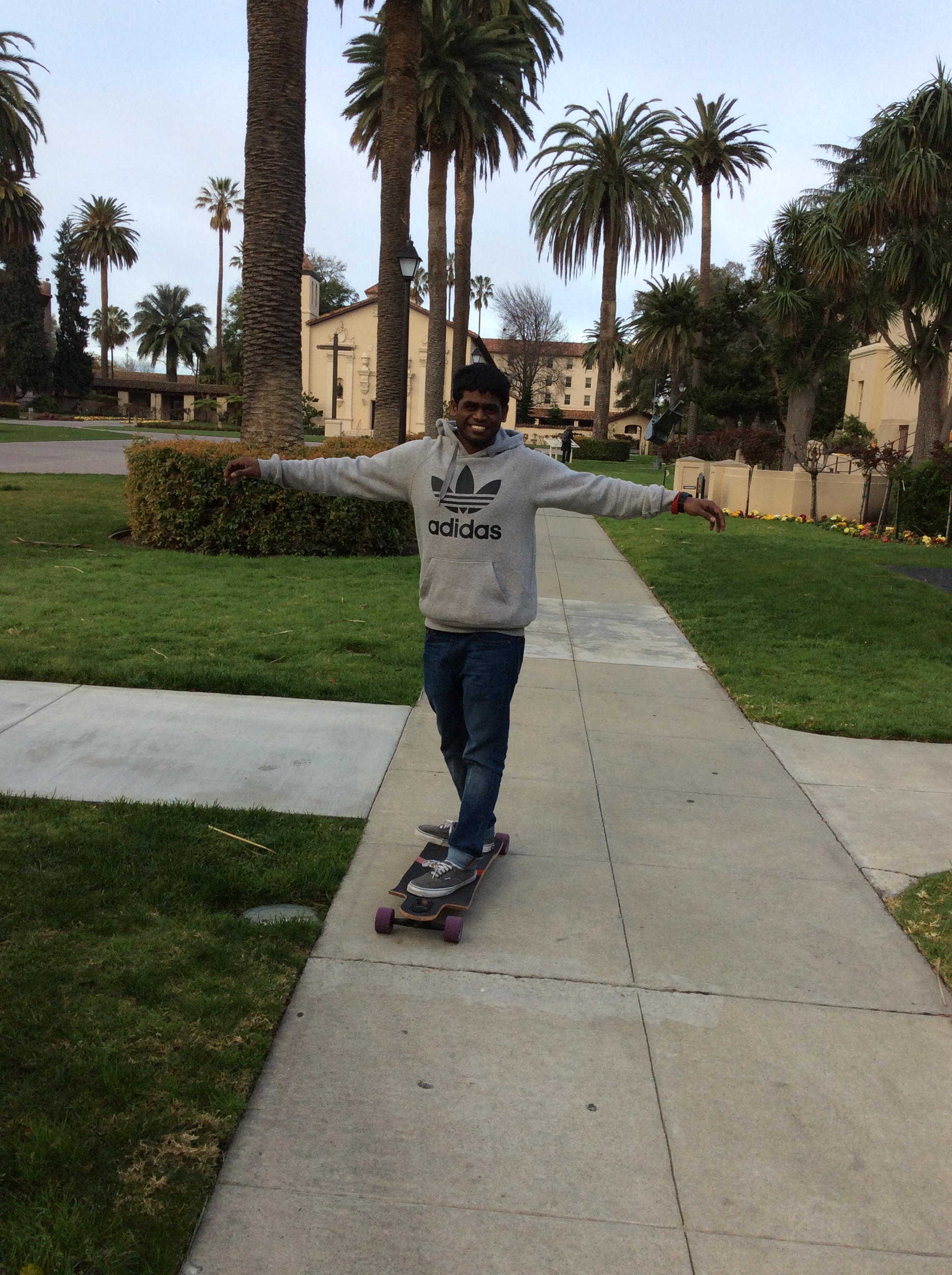 Person skateboarding on a sidewalk with palm trees in the background. image link to story