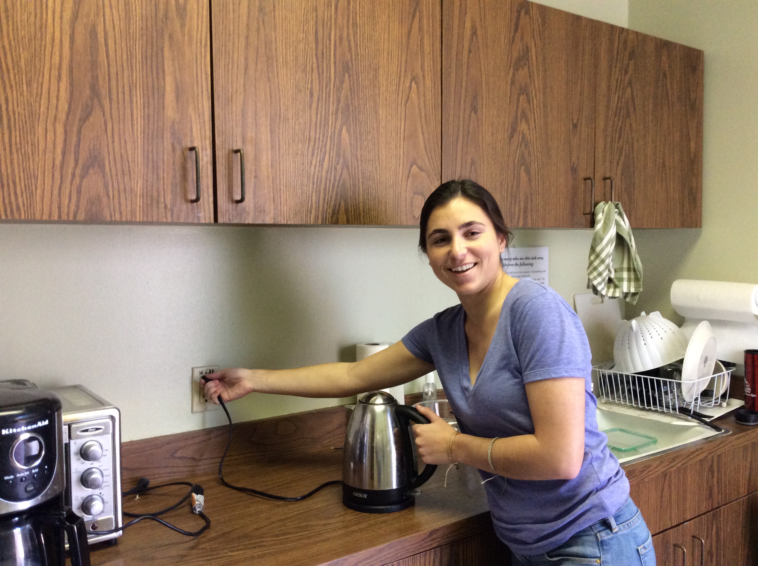 Person unplugging a small appliance in a kitchen. image link to story