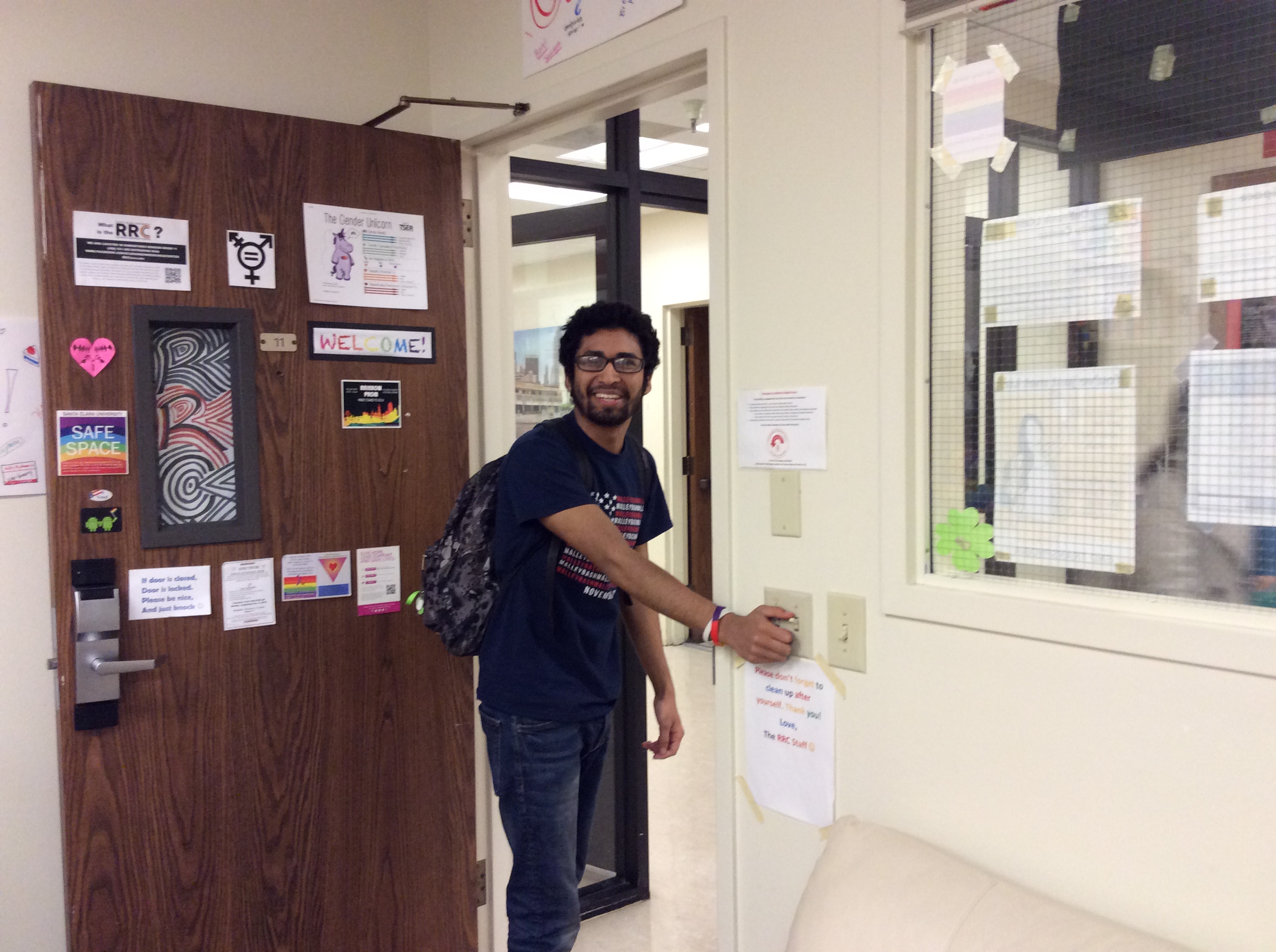 A person turning off the light switch beside a door. image link to story