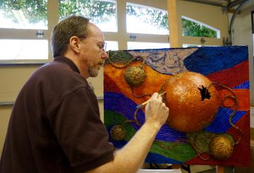 Dennis Jacobs paints a mixed media piece