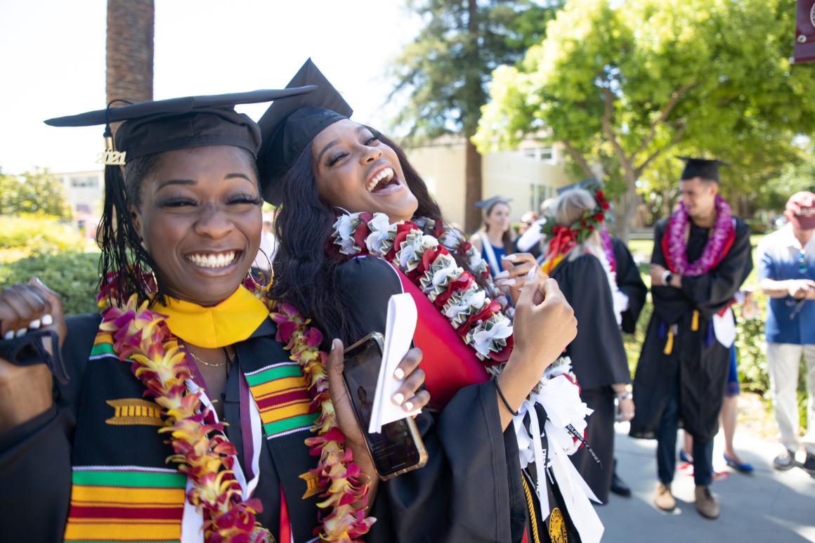 Santa Clara graduates in regalia on campus
