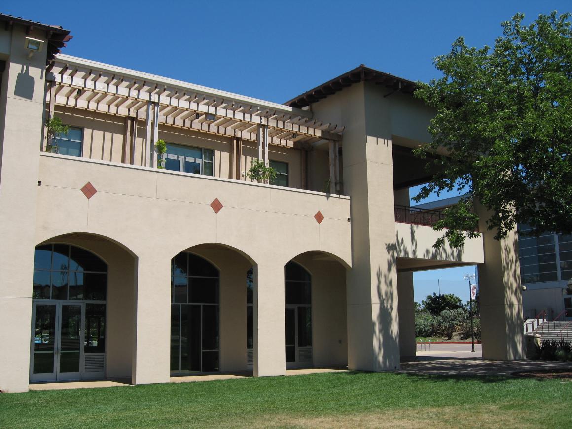 A cream-colored building with arched windows and a Locatelli sign. 