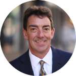 Smiling person in a suit and tie.