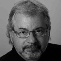 Black-and-white portrait of a man wearing glasses named Norman Kline.