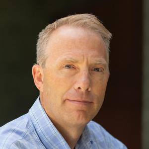 A person wearing a blue collared shirt.