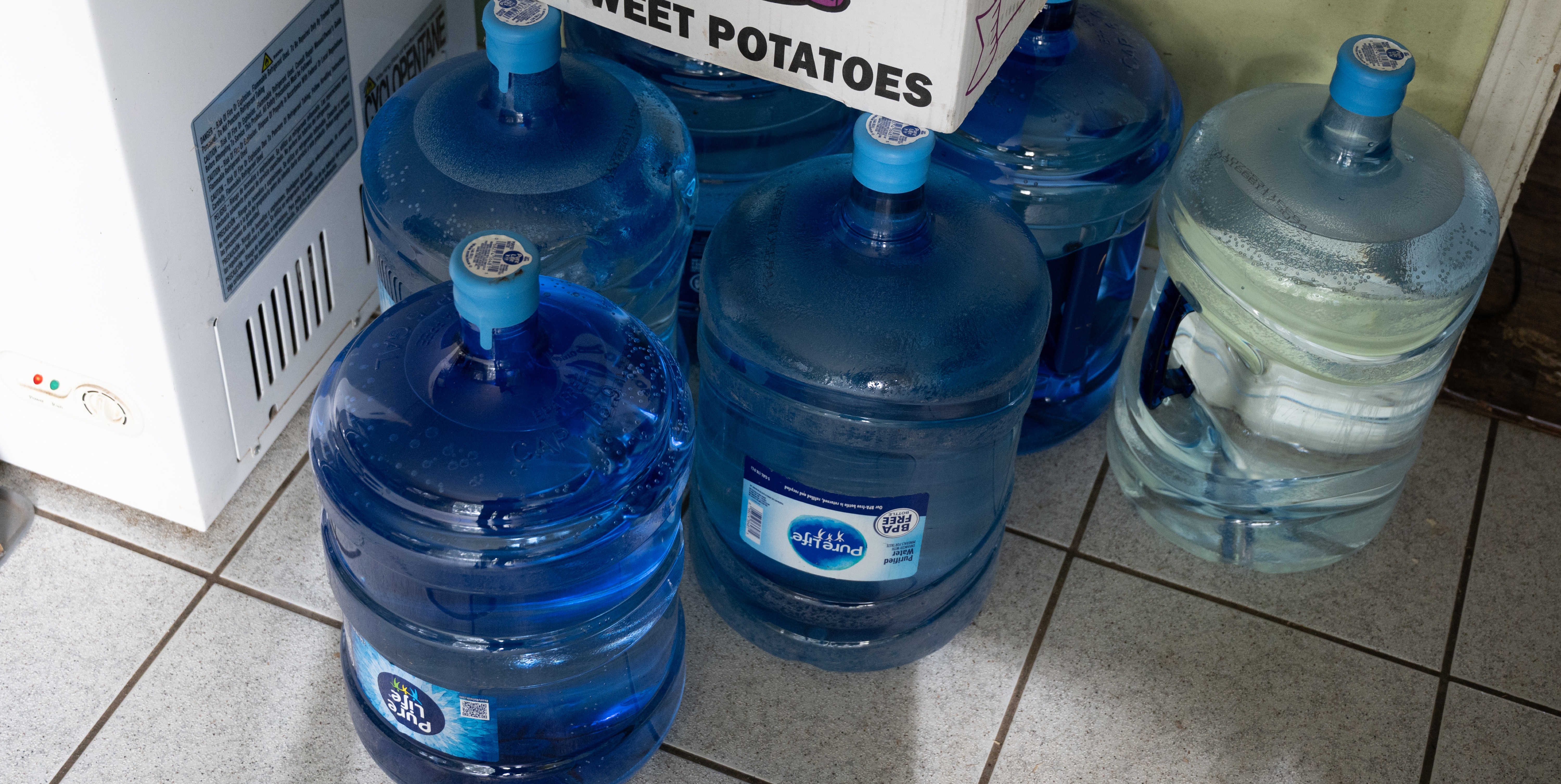 gallons of water packaged in blue plastic