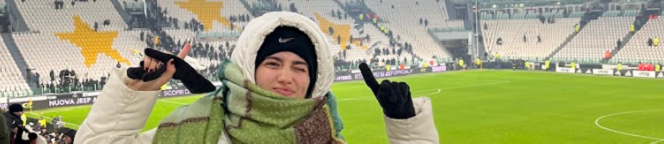 Decorative; student standing in a soccer stadium; links to Global Learning webpage