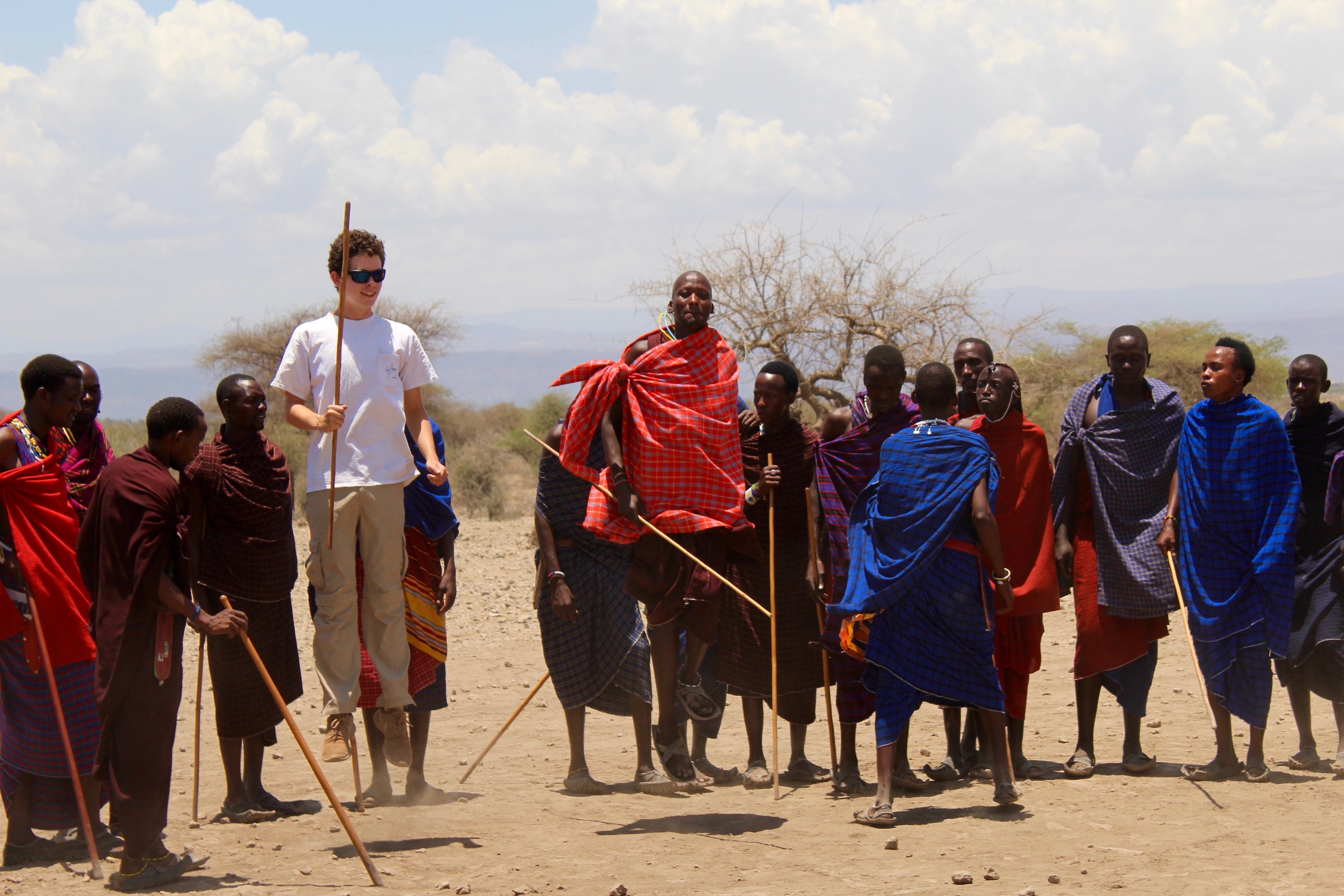 A group of Maasai people standing in an open area.