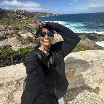 Decorative; student taking a selfie overlooking a coastline