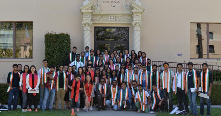 International Students with stoles of their country flags celebrating graduation