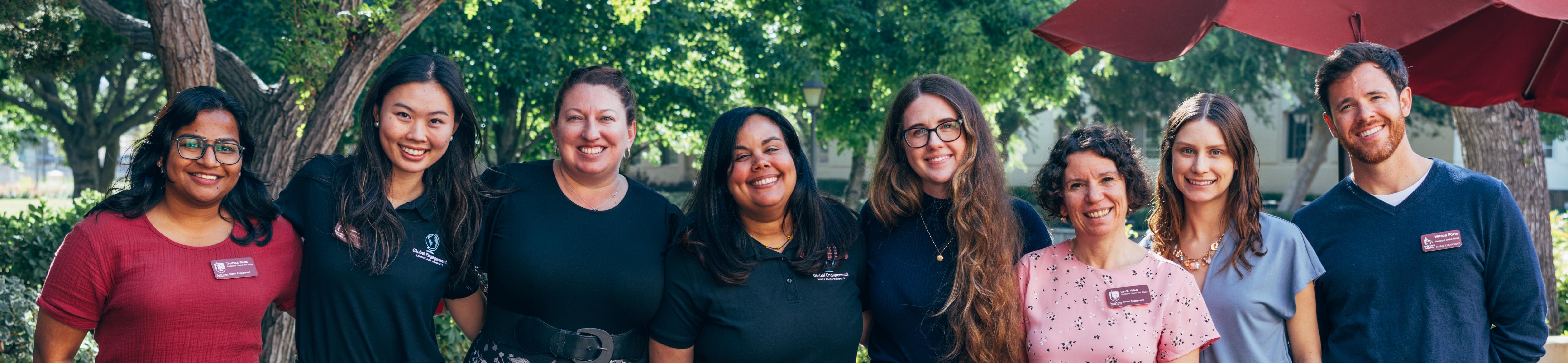 Decorative; ISS team smiling; links to International Students and Scholars webpage