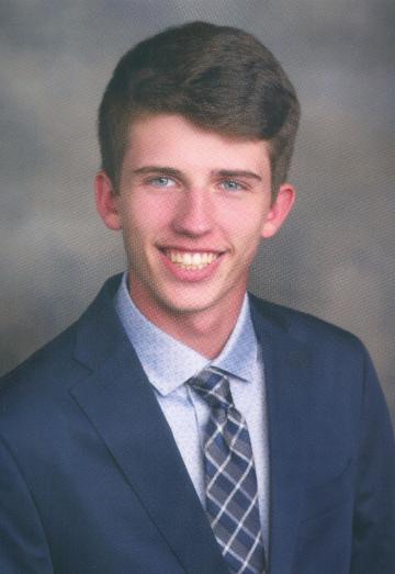 A person in a suit, smiling in a professional portrait.