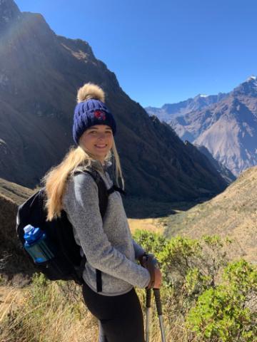 A person hiking in a mountainous landscape.