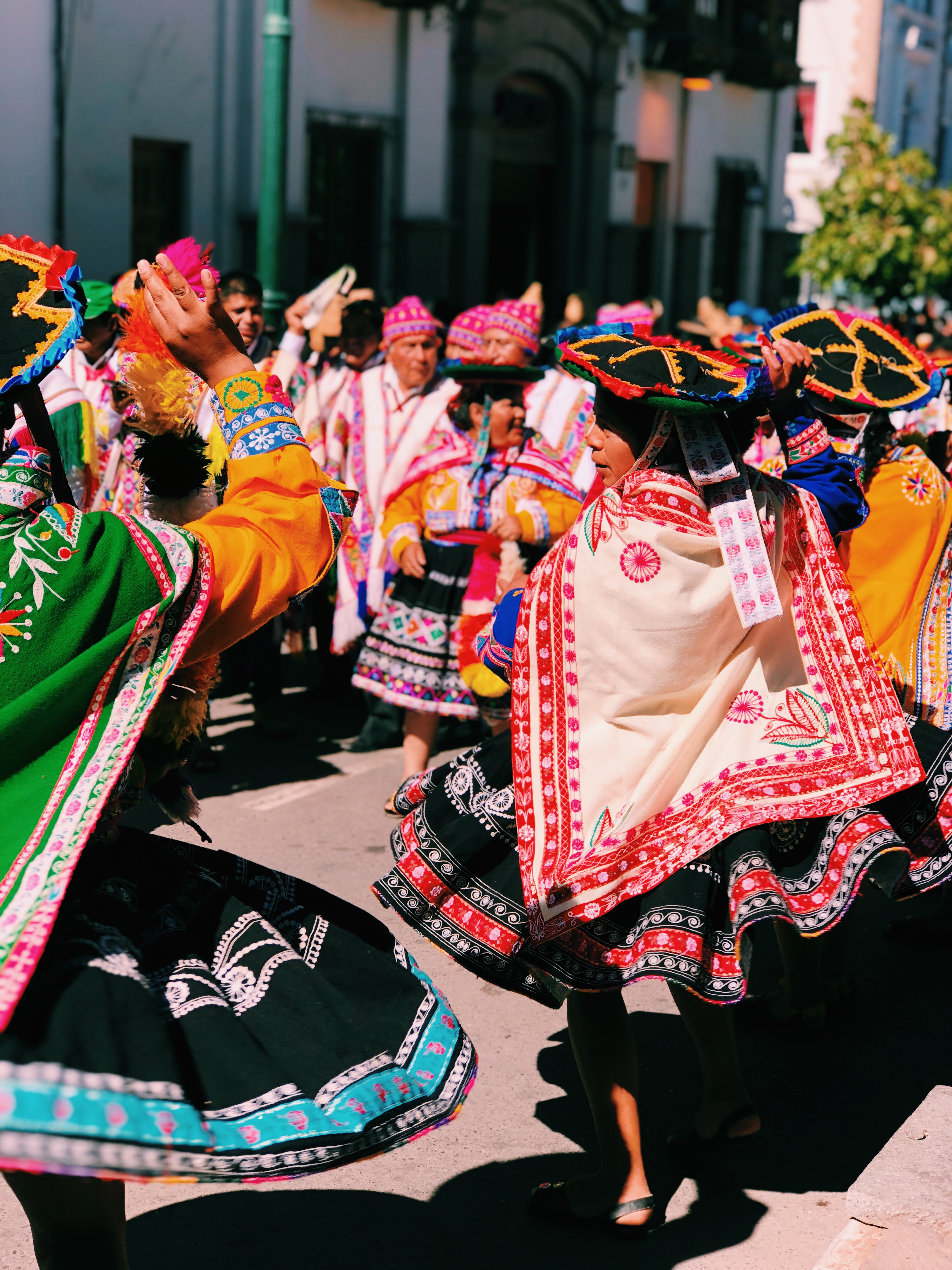 Colorful parade in Cusco featuring traditional attire and vibrant textiles.