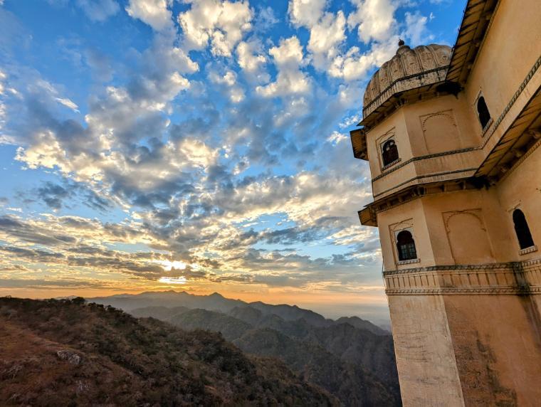 Kumbhalgarh Fort Complex in India with colorful sunset and landscape in the background