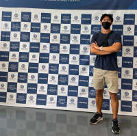 Beaumonte (Beau) Tse in front of a checkered background