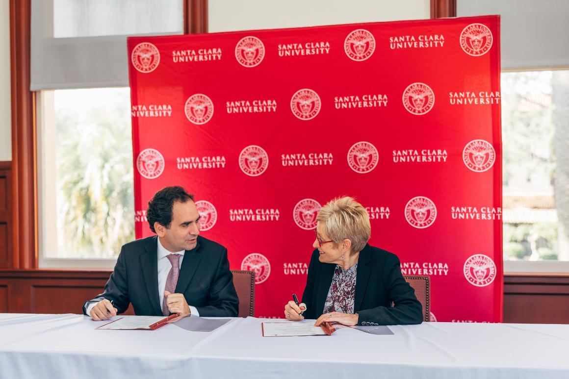 Decorative; President Julie Sullivan with delegate from University of Coimbra, Portugal signing a contract