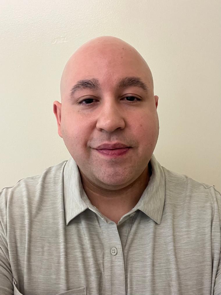 A man smiling into a camera.