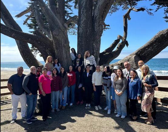 group sitting in front of tree 