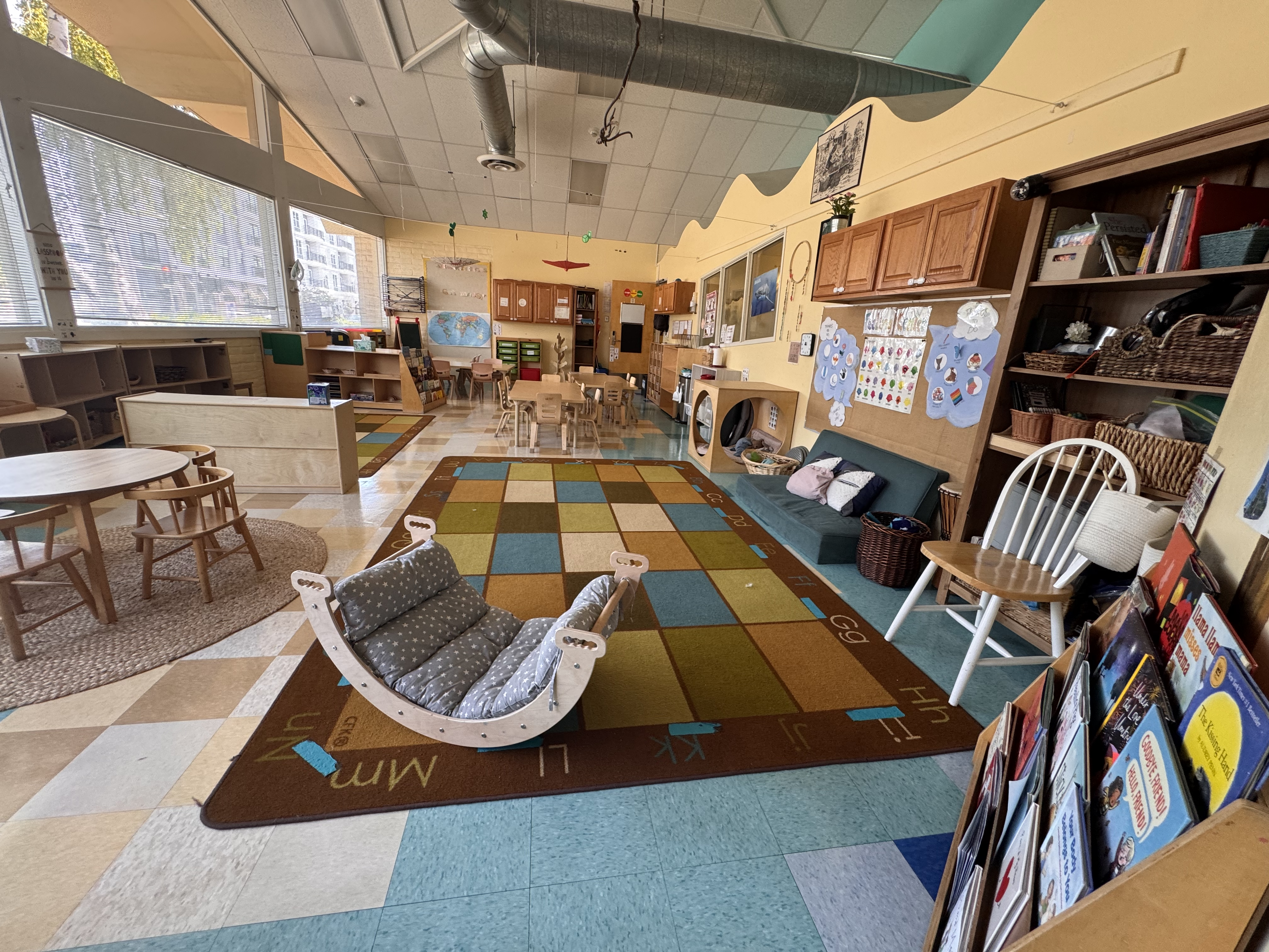Shark classroom open area, with a big carpet that has the abcs