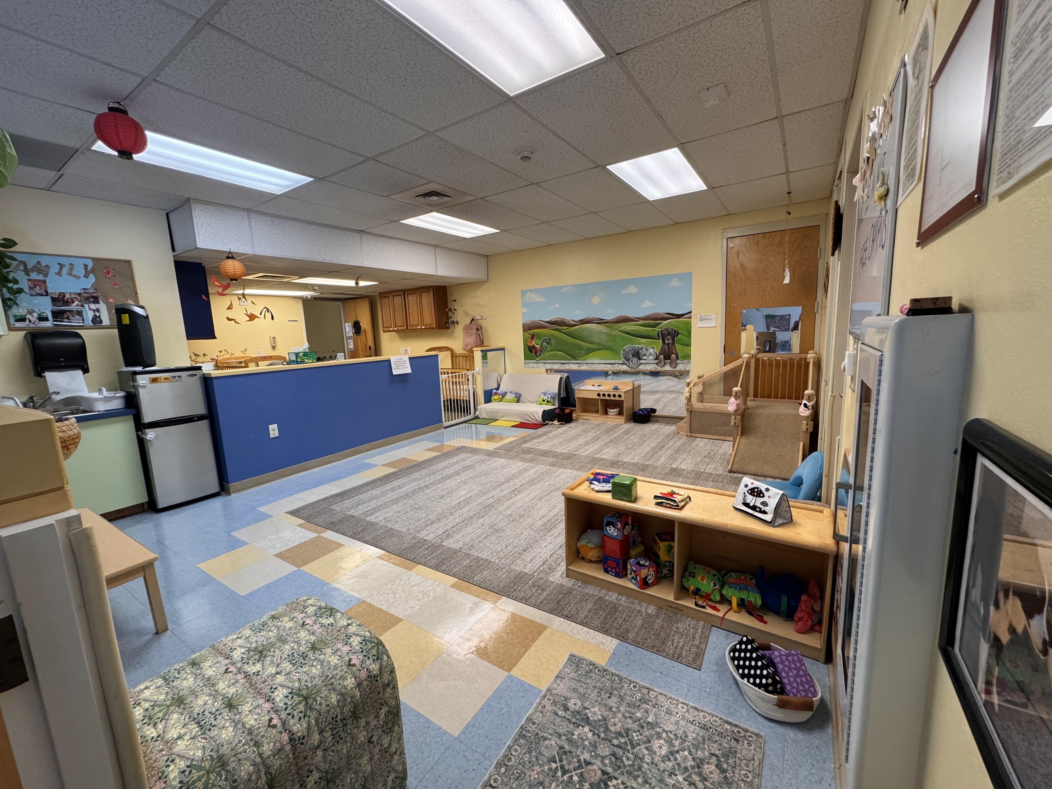 Starfish classroom which shows the fridge and nursery play area