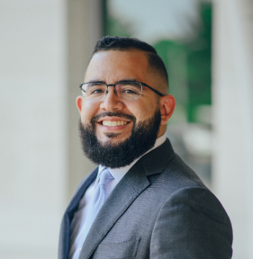 Man in grey suit smiling