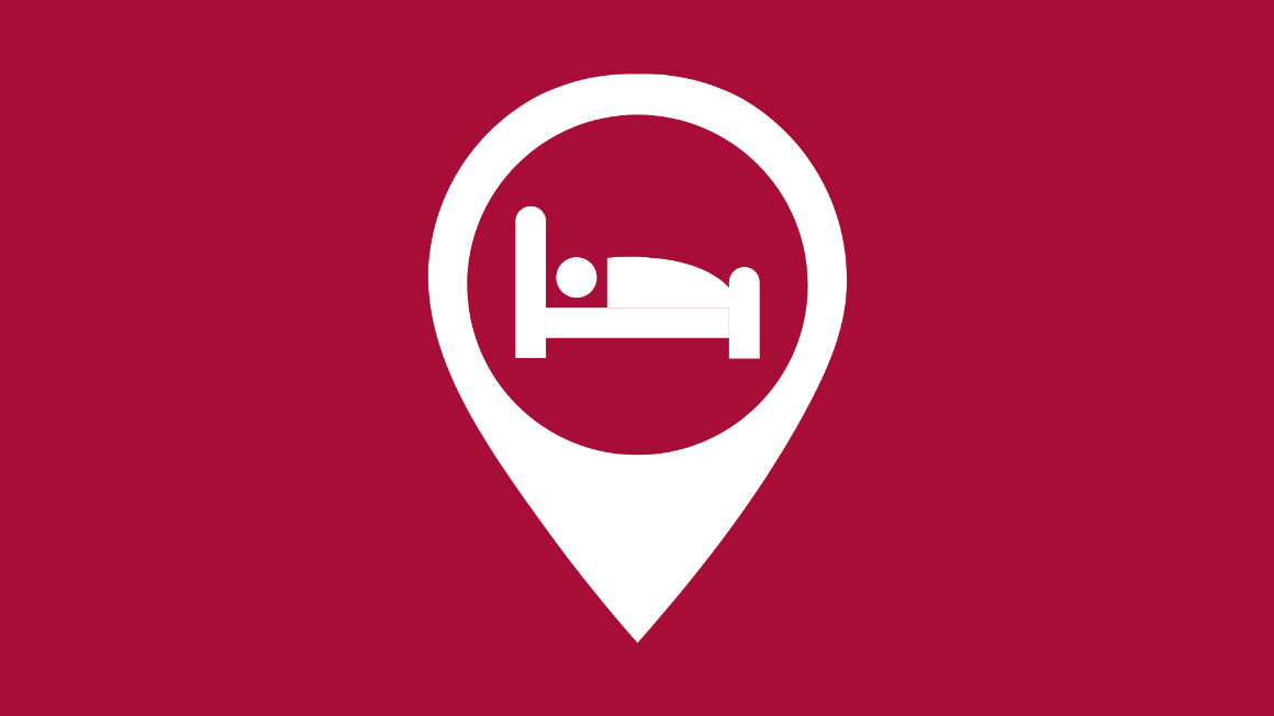Graphic of location pin with hotel bed 