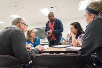 A group of people engaged in a classroom discussion.