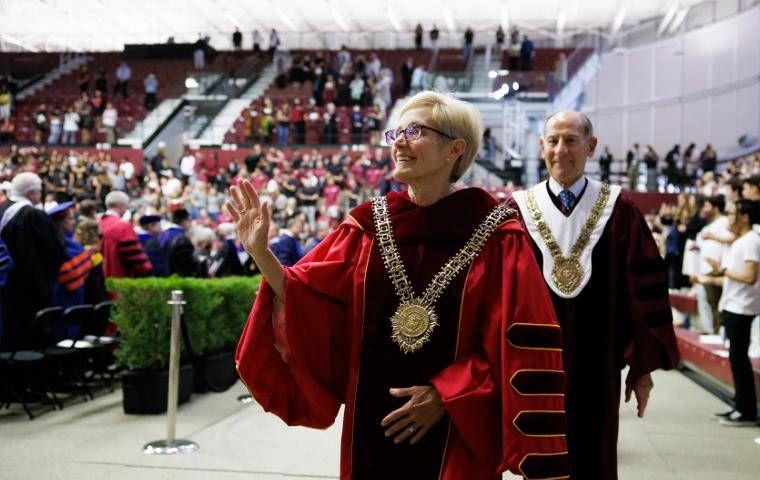 President Julie Sullivan walking through the crowd at inauguration in full regalia.