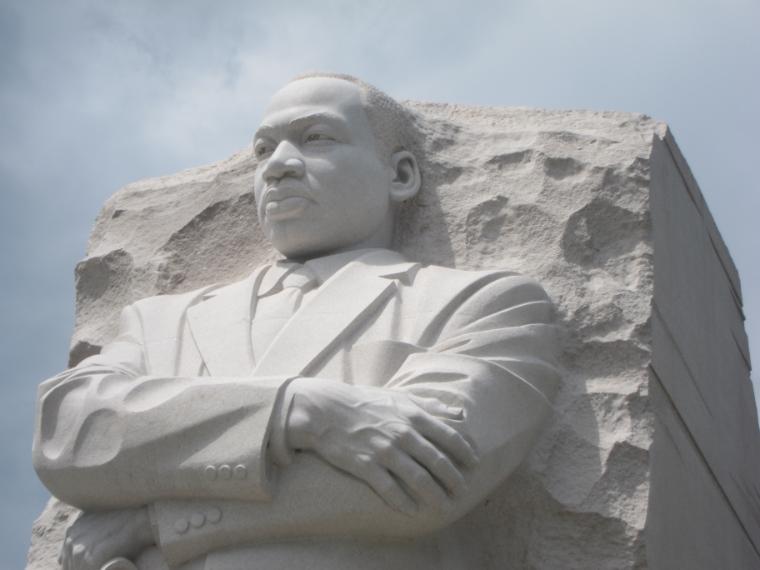 Statue of Martin Luther King Jr. with arms crossed.