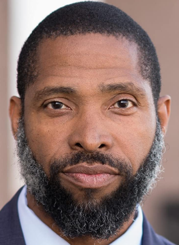 A man with a beard wearing a suit.