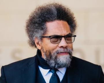 Headshot of Dr Cornel West wearing a suit and tie, looking slightly to his left