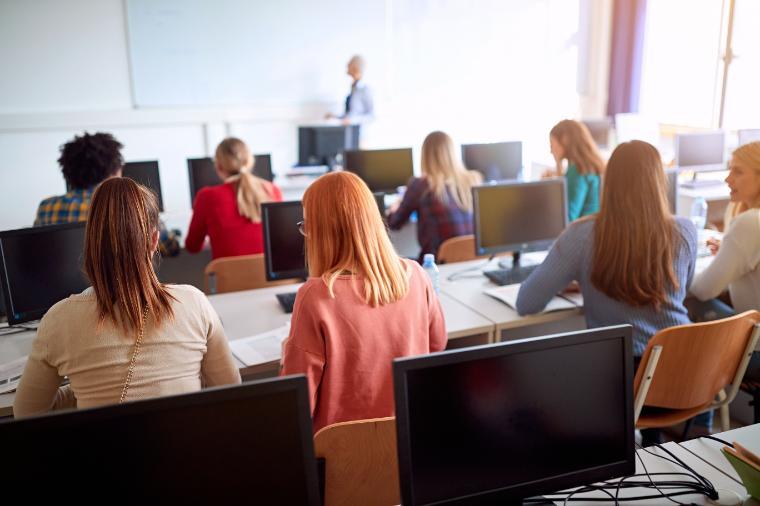 students sitting at computers in classroom setting
